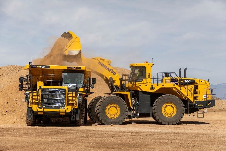 A WA700 wheel loader deposits a load into an HD605-10 haul truck at Komatsu's Arizona Proving Grounds in Sahuarita, Arizona.